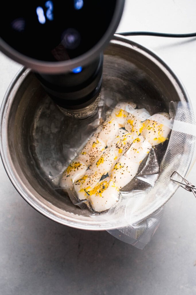 Scallops cooking in water bath.