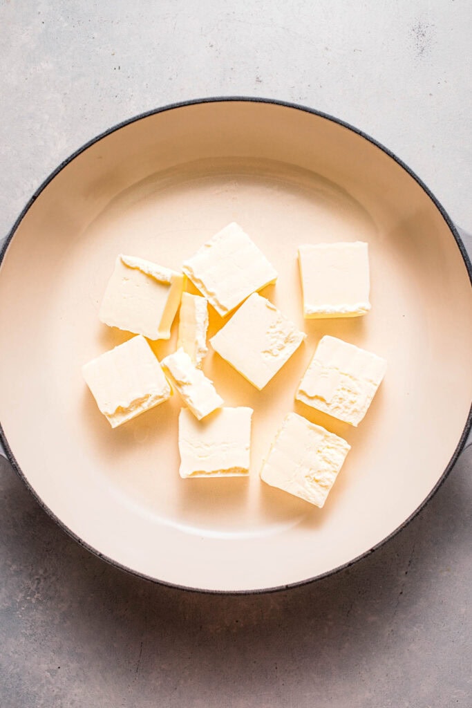 Butter cubes in skillet. 
