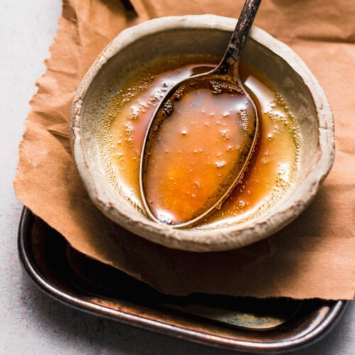 Browned butter in small bowl with spoon.