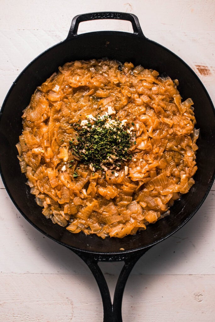 Thyme and garlic added to skillet.