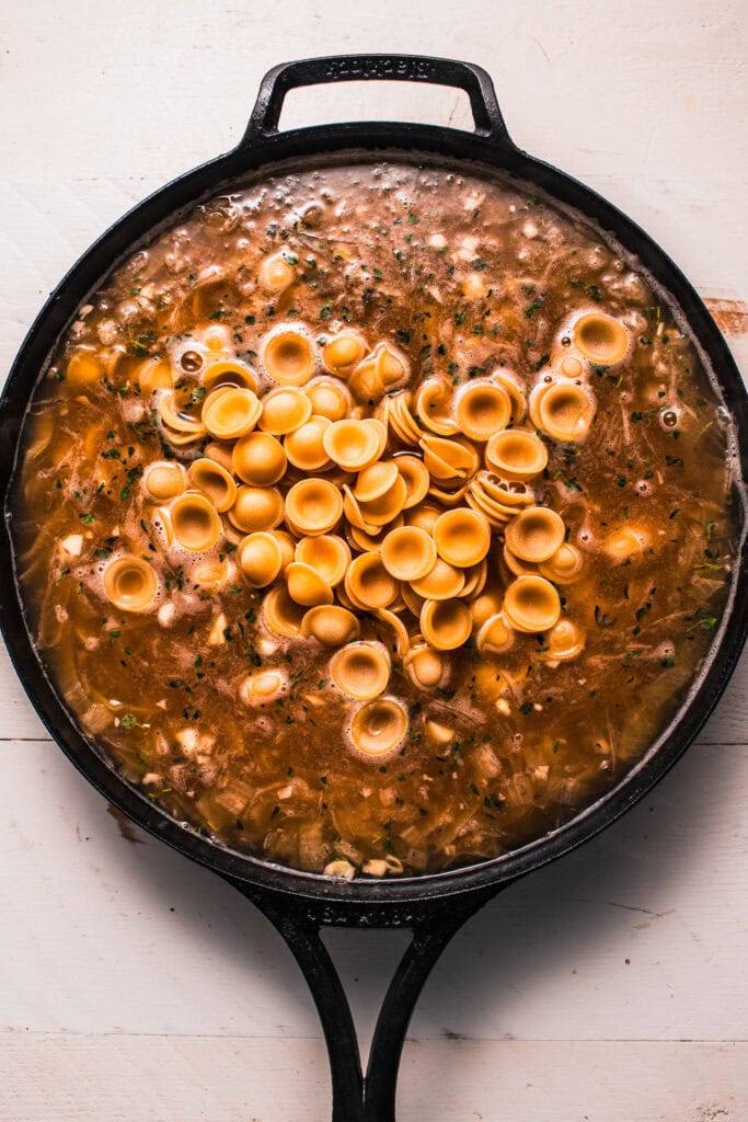 Broth and pasta added to skillet.