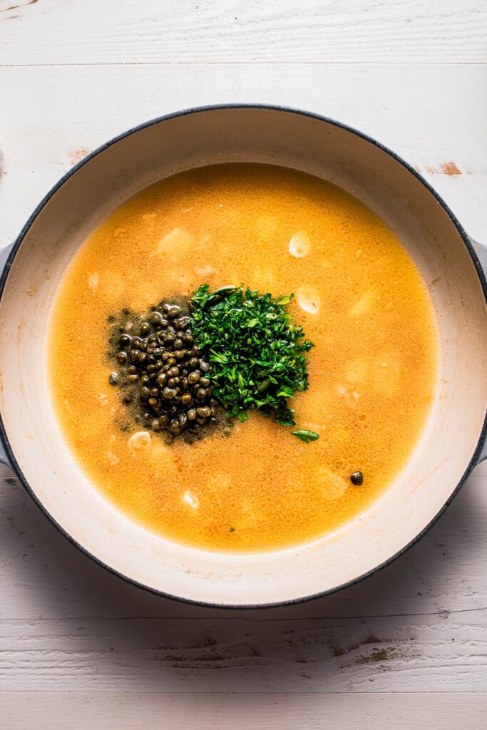 Parsley and capers added to skillet.