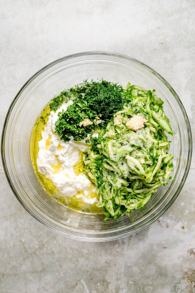 Tzatziki sauce being mixed together in bowl.