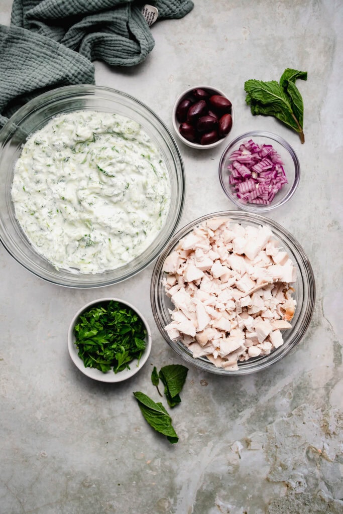 Ingredients for tzatziki chicken salad on counter.