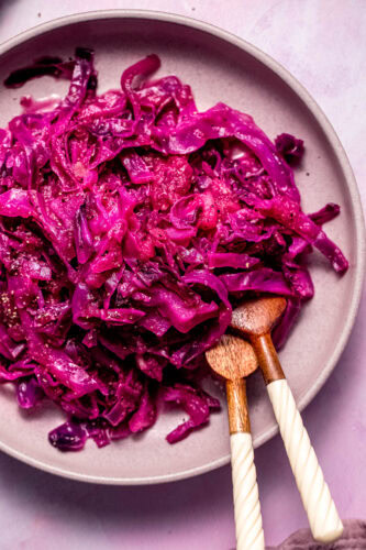 Finished braised red cabbage in pink serving bowl.