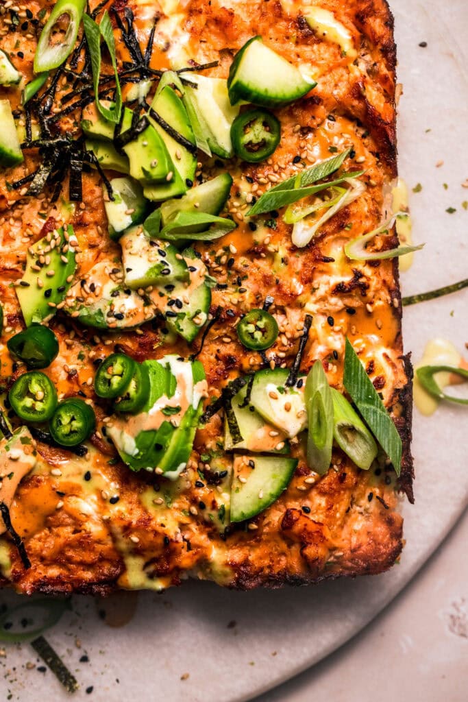 Overhead close up of finished sush bake drizzled with sriracha sauce and creamy wasabi mayo.
