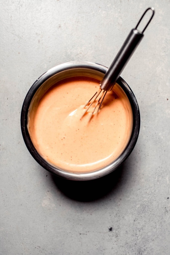 BBQ aioli being whisked together.