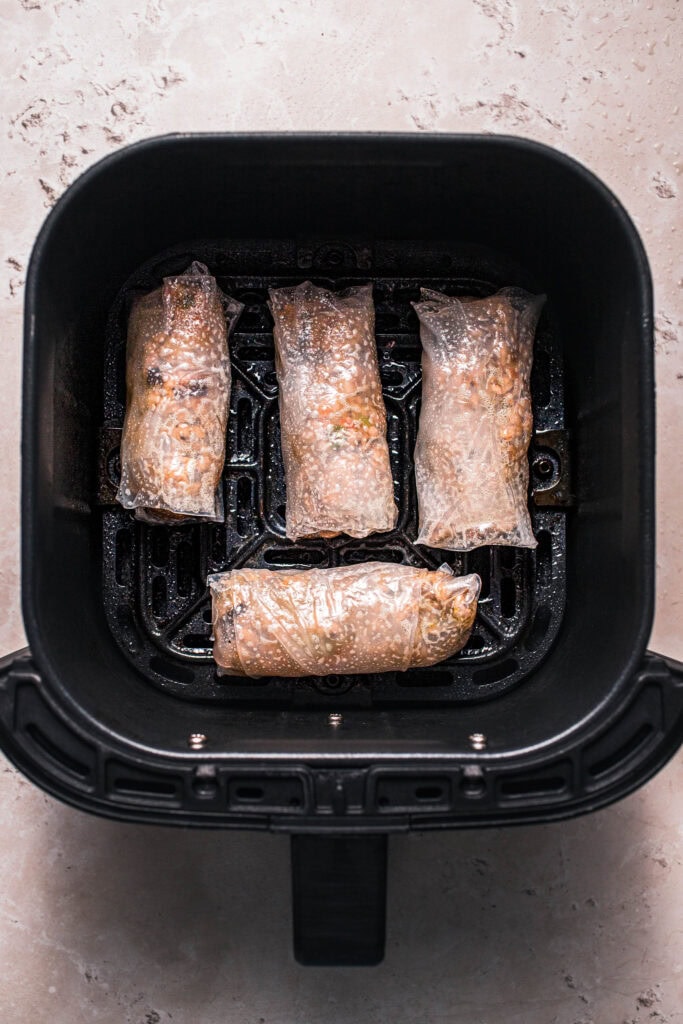 Rice paper dumplings in air fryer basket.