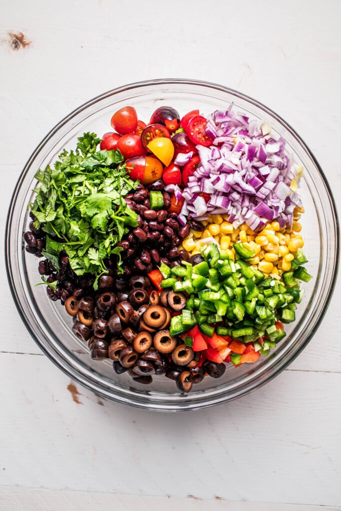 Ingredients for mexican pasta salad in bowl before tossing.