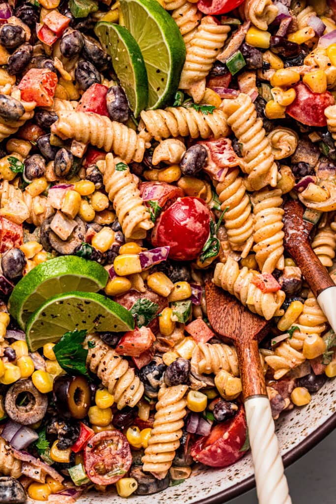 Overhead extreme close up of Mexican pasta salad in serving bowl.