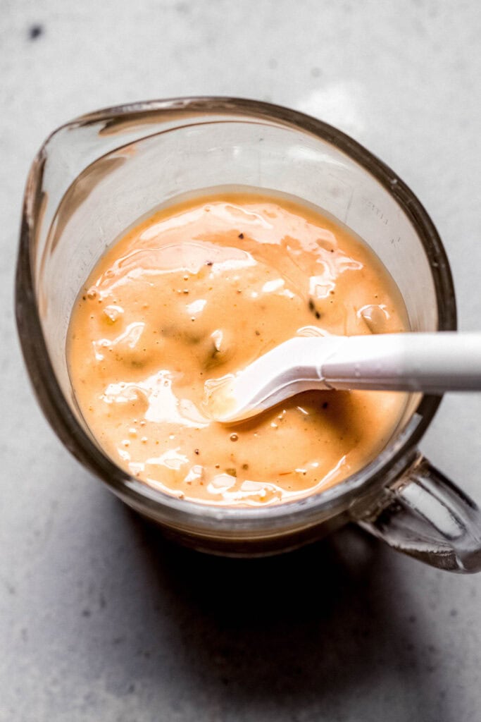 Smashburger sauce being mixed together in measuring cup.