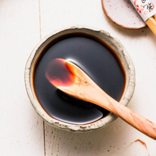 Prepared fried rice sauce in small bowl with wooden spoon.