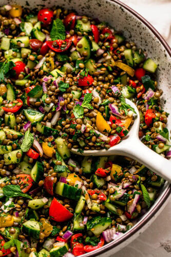 Overhead close up of lentil tabbouleh salad with serving spoon.