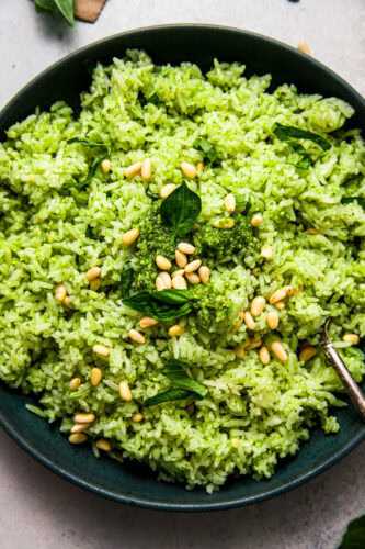 Overhead close up of green pesto rice in serving bowl.
