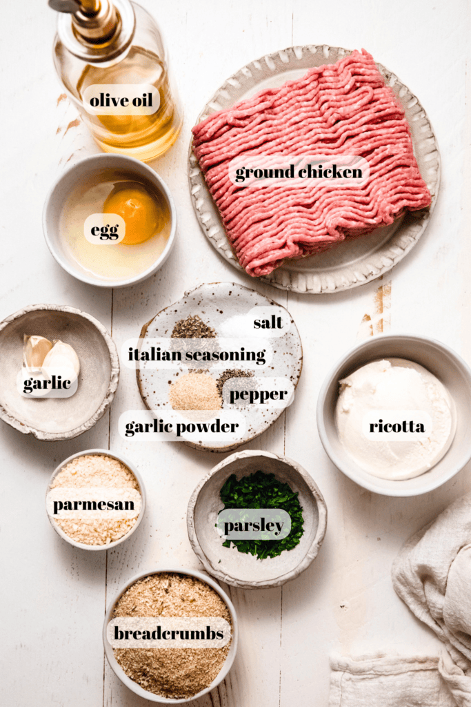 Ingredients for chicken ricotta meatballs labeled on counter.
