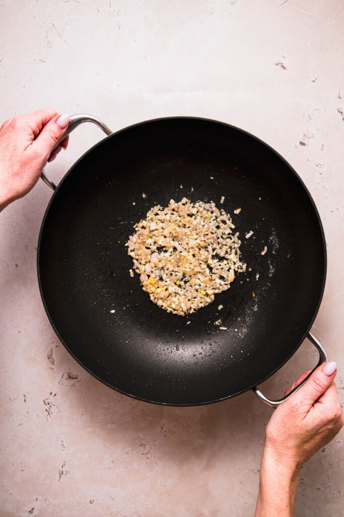 Shallots and garlic added to wok.