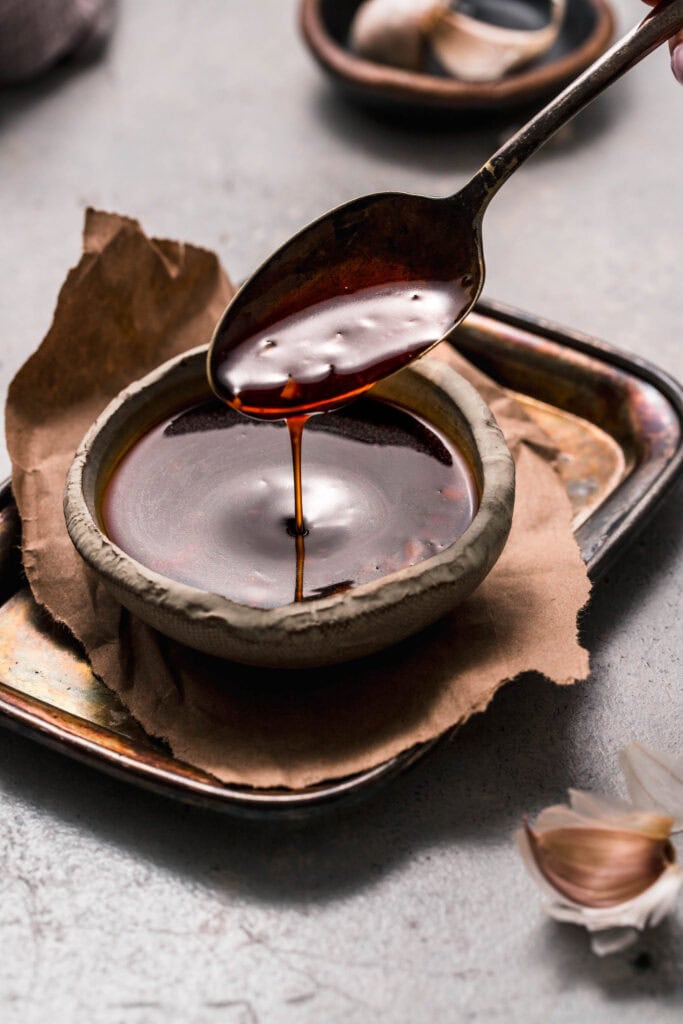 Spoon drizzling teriyaki sauce.