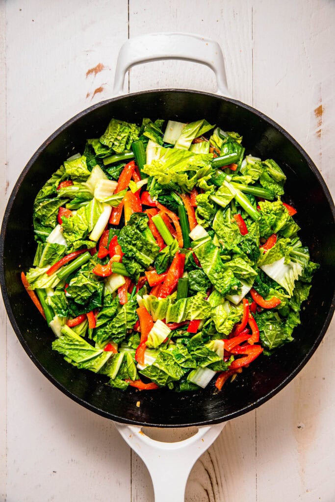 Cabbage and peppers added to skillet.