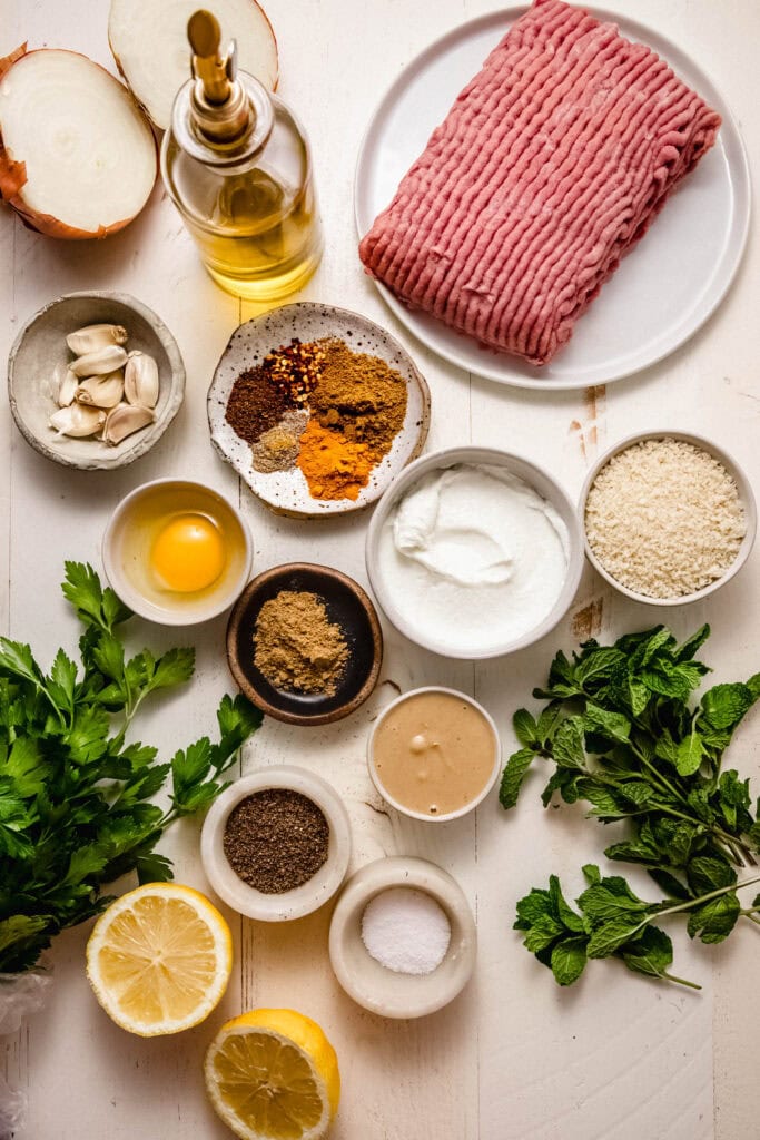 Ingredients for chicken shawarma meatballs on counter.