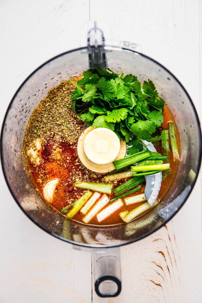 Herb marinade ingredients in a blender for grilled carne asada.