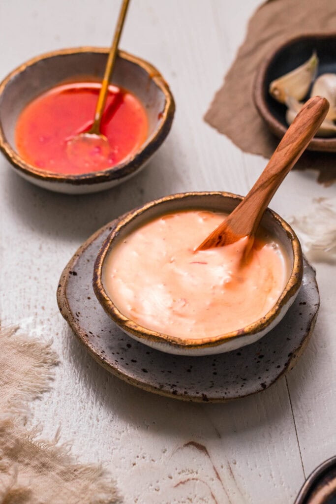 Side view of small bowl of sweet chili aioli.
