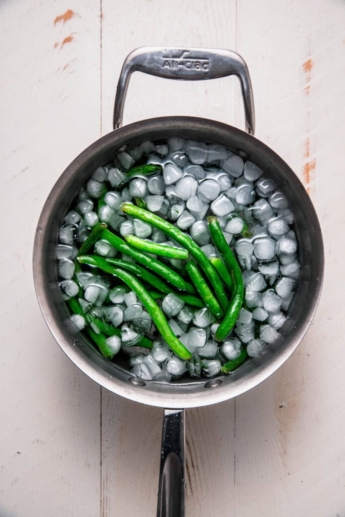 Blanched green beans in ice bath.