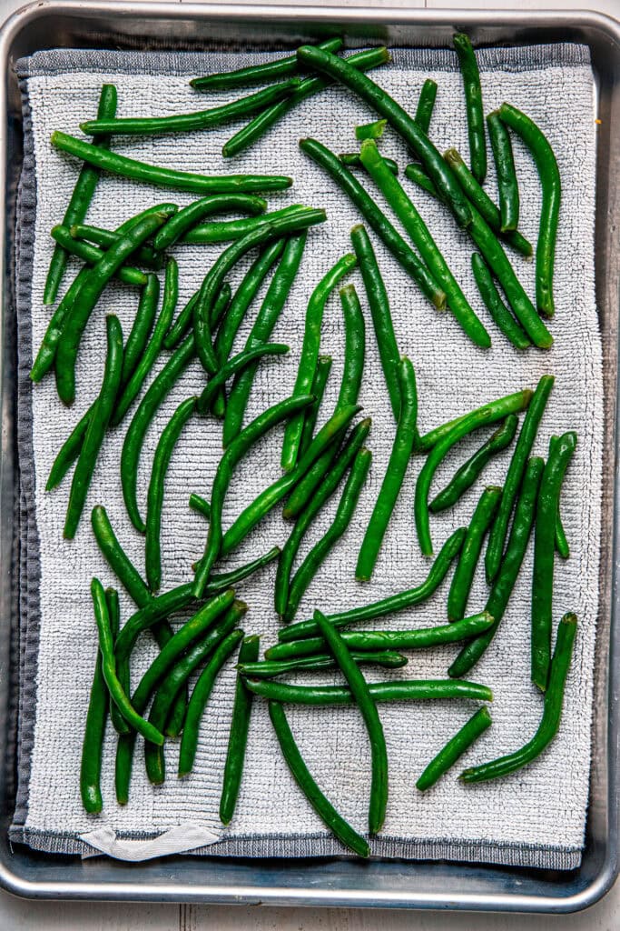 Green beans drying on towels.