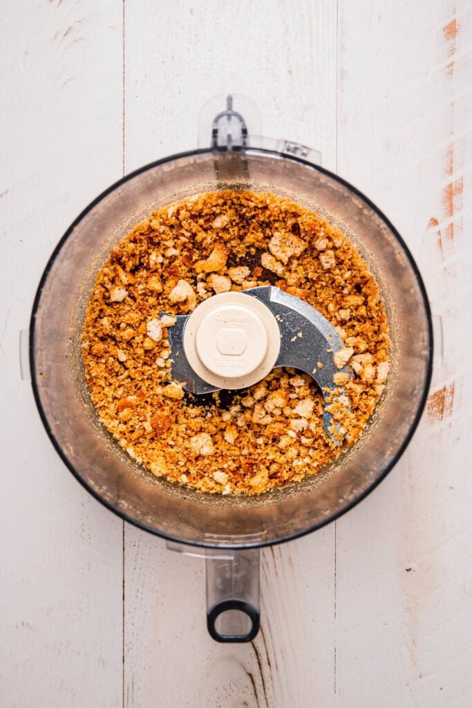 Breadcrumbs being made in food processor.