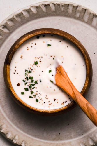 OVERHEAD CLOSE UP OF BOWL OF PREPARED CREAMY HORSERADISH SAUCE.
