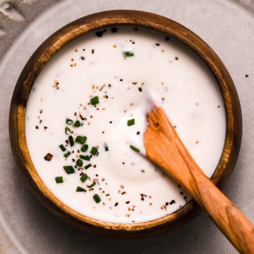 OVERHEAD CLOSE UP OF BOWL OF PREPARED CREAMY HORSERADISH SAUCE.