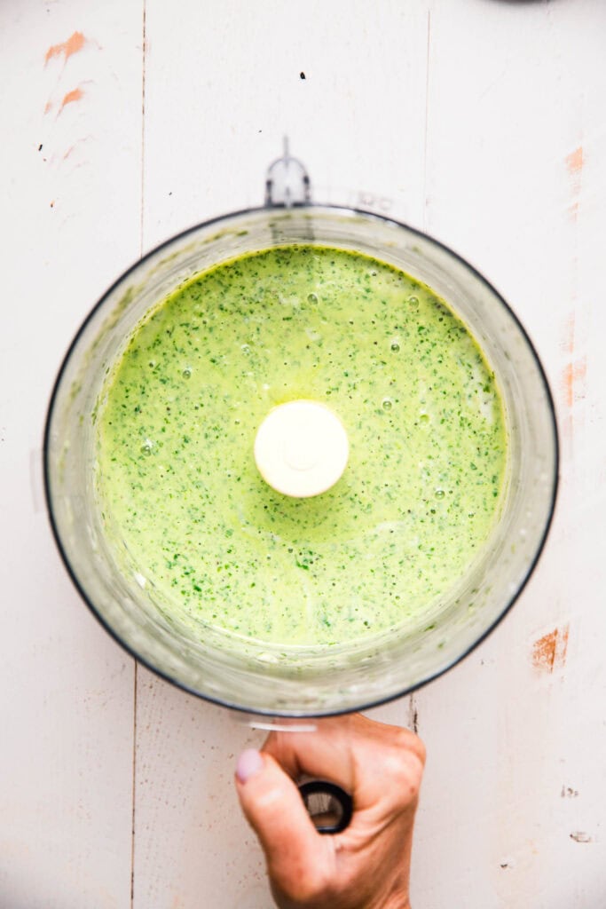 Green goddess sauce in food processor bowl. 