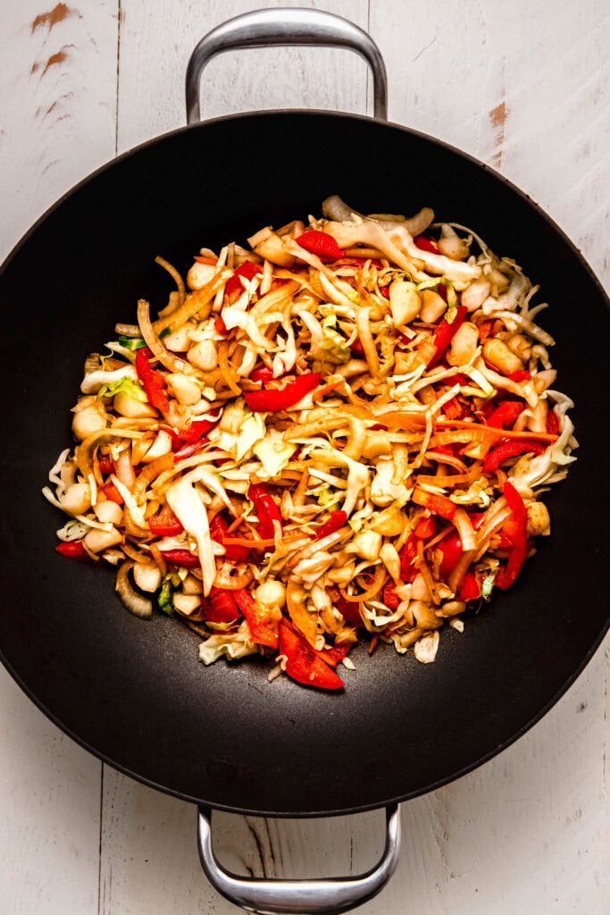 Cabbage and peppers added to wok.