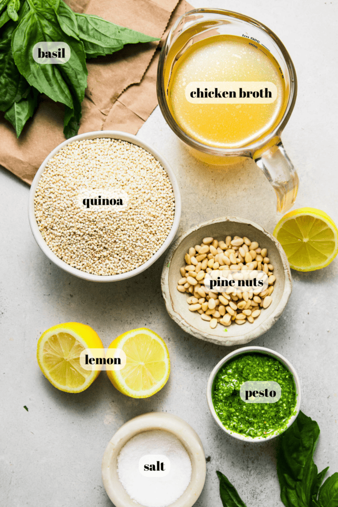 Ingredients for pesto quinoa labeled on counter.