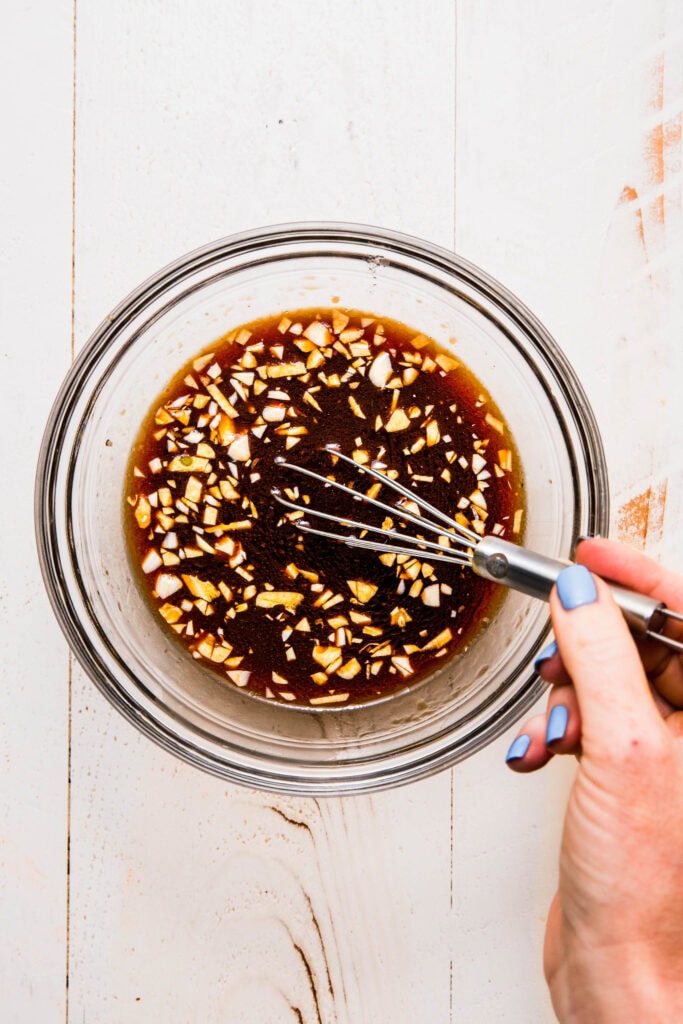 Sauce being whisked together. 