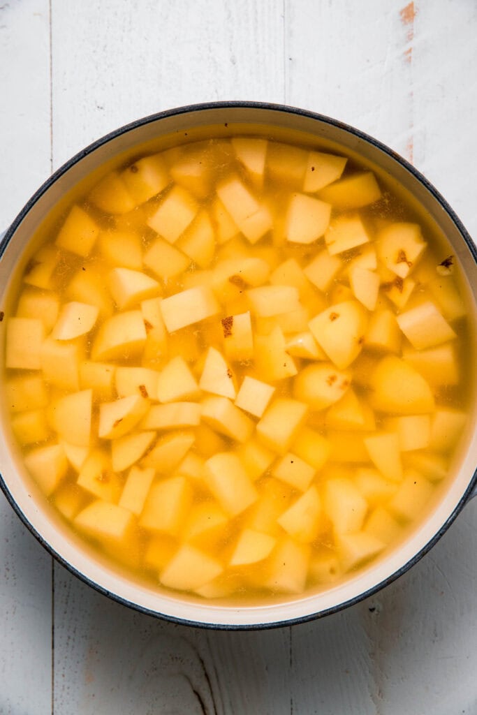 Potato cubes in pot of boiling water.