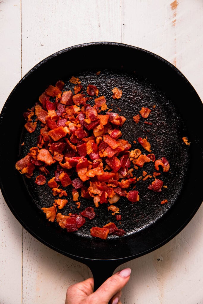 Bacon crisping in skillet.