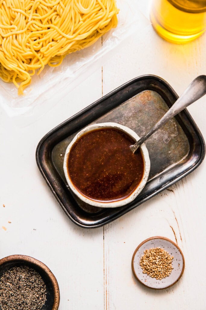 Small bowl of yakisoba sauce with spoon.