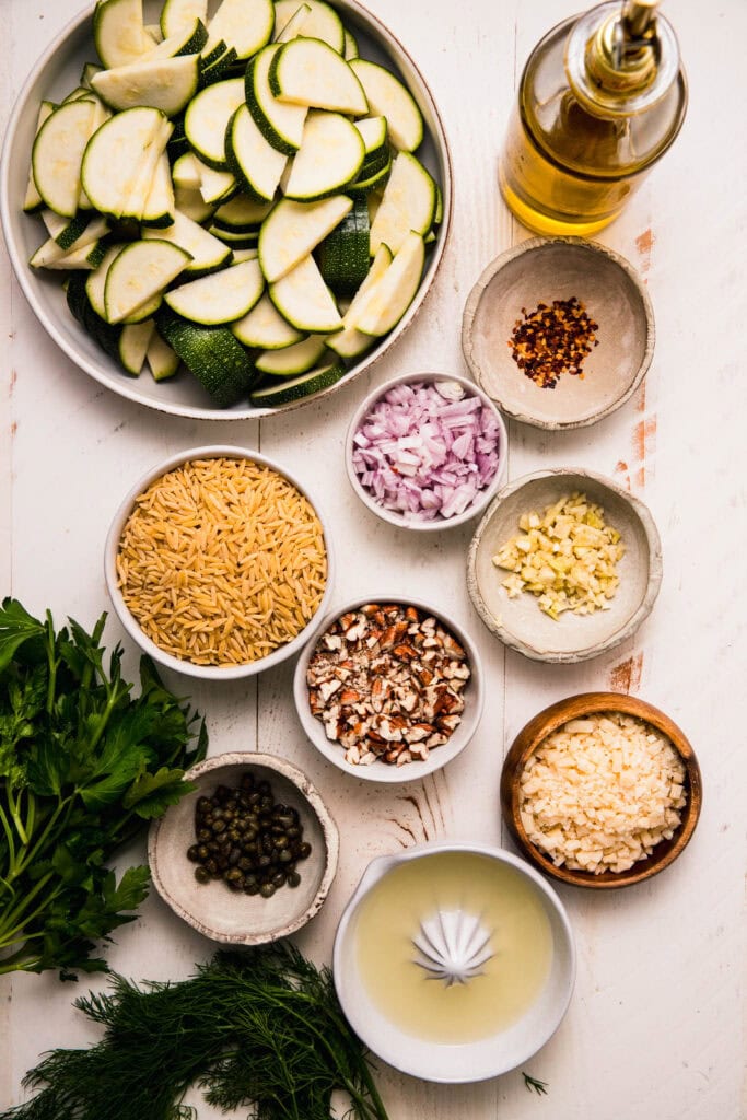 Ingredients for zucchini orzo salad on counter.