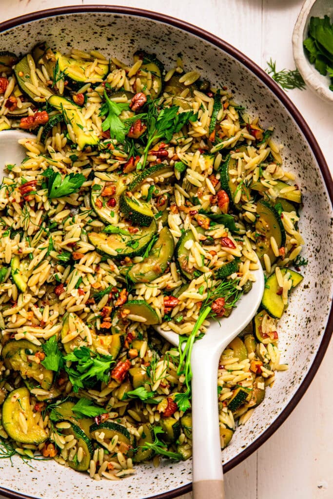 Overhead close up of bowl of zucchini orzo salad.